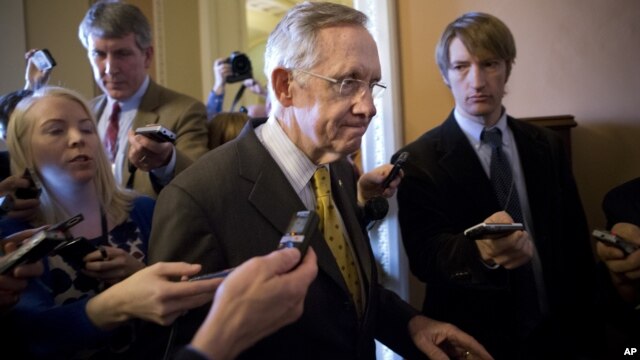 Senate Majority Leader Harry Reid, D-Nev., walks to a closed-door meeting with fellow Democrats as he and Senate Minority Leader Mitch McConnell, R-Ky., work to negotiate a legislative path to avoid the so-called "fiscal cliff," at the Capitol in Washingt