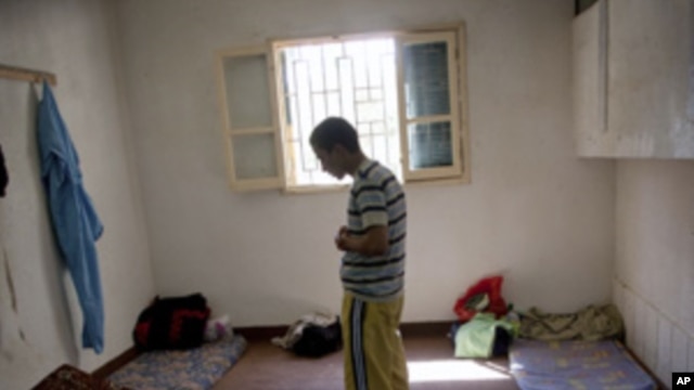 In this Sept. 22, 2011 file photo, a man suspected of being a Gadhafi loyalist prays in a detention facility in Misrata, Libya.