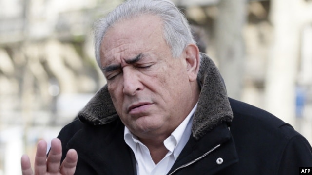 Former International Monetary Fund chief Dominique Strauss-Kahn gestures as he leaves a restaurant in Paris, December 11, 2012.