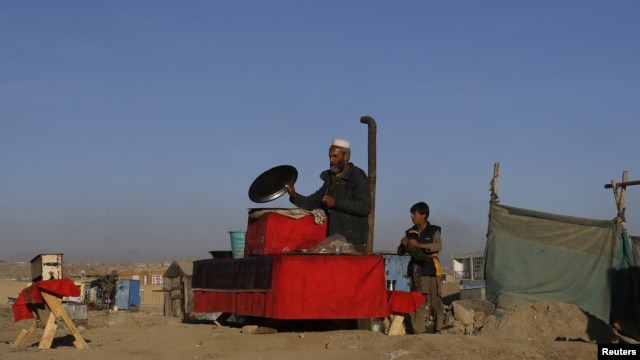 An Afghan man prepares food at his roadside restaurant in Kabul, November 14, 2012.