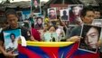 Exile Tibetans carry portraits of Tibetans who have immolated themselves in Tibet protesting Chinese rule, during a street protest in Dharmsala, India, Aug.29, 2012. 