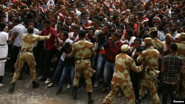 FILE - Security forces work to contain demonstrators at an anti-government rally in Bishoftu town, Oromia region, Ethiopia, Oct. 2, 2016. Initially triggered by land issues, the protests have shifted to include human rights and political power.
