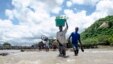 People cross a river with their belongings where a bridge once stood in Phaloni, Malawi, Jan. 22, 2015. 