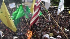 Muslims burn an American flag following a protest over an anti-Islam video that denigrates the Prophet Muhammad, in Kaduna, Nigeria, September 24, 2012.