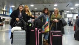 Preparing to board their train home, out-of-towners Sandy (second from right) and her friends are grateful they survived their unexpected adventures in New York. (VOA/A. Phillips)