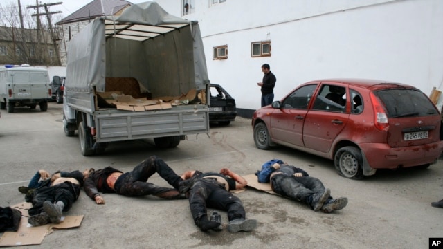 Bodies of four killed suspected militants are seen in Derbent region of Dagestan, April 18, 2011.