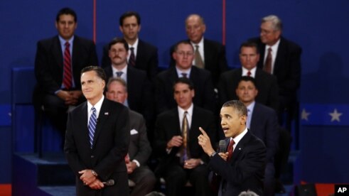 President Barack Obama speaks as Republican presidential candidate Mitt Romney listens during the second presidential debate at Hofstra University, Hempstead, New York, October 16, 2012.