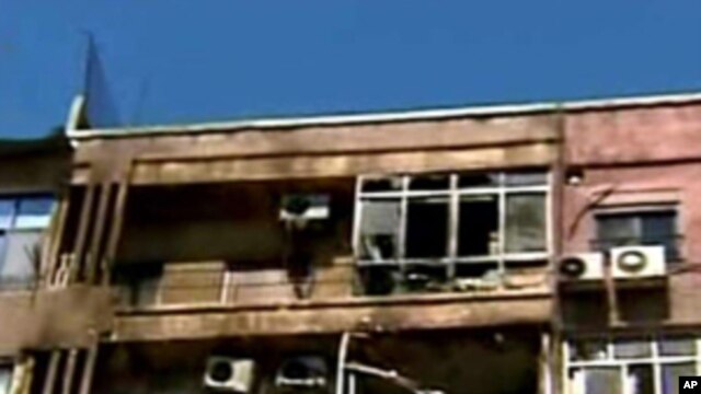 In this photo released by the Syrian official news agency SANA, damaged apartments are seen after a clashes between the Syrian rebels and the Security forces, in the Mazzeh neighborhood of Damascus, Syria, on Monday, March 19, 2012.
