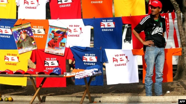 A peddler offer t-shirts with images of late Venezuelan President Hugo Chavez in front of the Military Academy in Caracas, Mar. 14, 2013. 