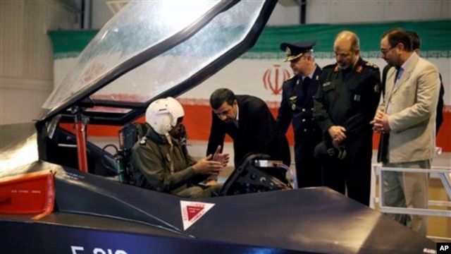 Presiden Iran Mahmoud Ahmadinejad mendengarkan penjelasan pilot pesawat jet tempur Qaher. (Foto: AP)