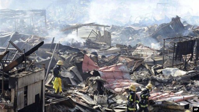 Rescuers conduct search operation amidst smoldering debris in Kesennuma, northern Japan Monday, March 14, 2011 following Friday's massive earthquake and the ensuing tsunami. (AP Photo/Yomiuri Shimbun, Miho Ikeya) JAPAN OUT, MANDATORY CREDIT