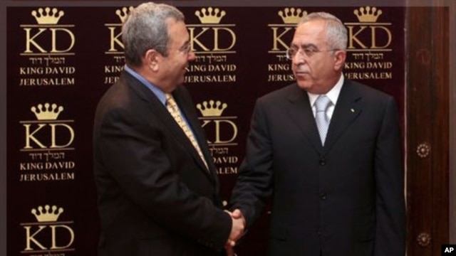 Israeli Defense Minister Ehud Barak, left, shakes hands with Palestinian Prime Minister Salam Fayyad (file photo).