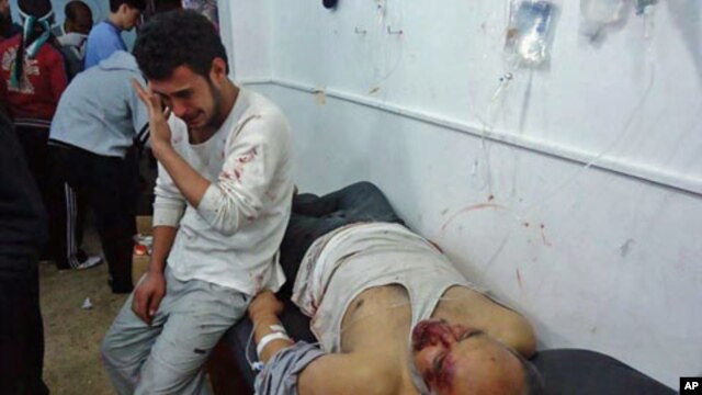 Wounded men are seen in the Sunni Muslim district of Baba Amr in Homs, Syria, February 8, 2012.