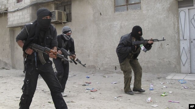 Free Syrian Army fighters train in a neighborhood of Damascus, Syria
