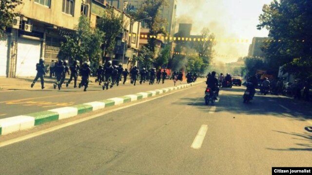 A user generated photo appears to show riot police following protesters down Saadi Street in Tehran. Via Saeed Valadbaygi on TwitPic