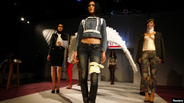 Models pose on a makeshift catwalk during a fashion show organized by environmental group Greenpeace titled 'Toxic Threads - The Big Fashion Stitch-Up', in Beijing, November 20, 2012. 