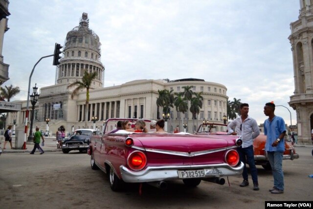 People gather on the street in Old Havana. U.S. President Barack Obama is scheduled to visit the historic area shortly after his arrival late Sunday afternoon.