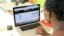 A woman looks at a Ushahidi website set up to monitor Kenya's national election earlier this year. (J. Craig/VOA)