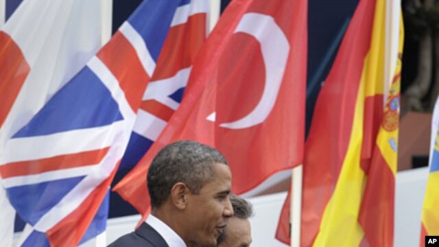 U.S. President Barack Obama (L) walks with French President Nicholas Sarkozy, after Obama's arrival at Espace Riviera for the G20 summit in Cannes, France, November 3, 2011.