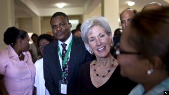 U.S. Secretary of Health and Human Services Kathleen Sebelius, center, talks to a health worker during a visit to Eliazar Germain hospital in Port-au-Prince, Haiti, April 16, 2012.