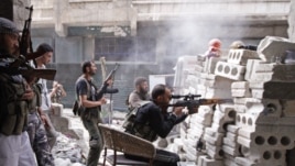 Members of the Free Syrian Army are seen at a front line in al-Mid area in Aleppo city in northern Syria, October 11, 2012. 