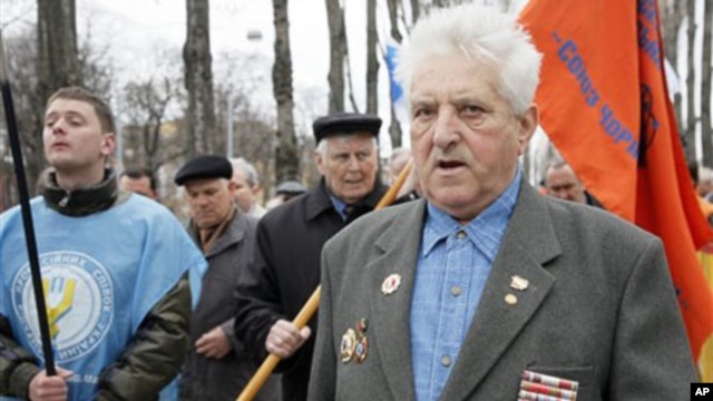Chernobyl veterans walk during a rally in Kiev, Ukraine, Sunday, April 17, 2011.