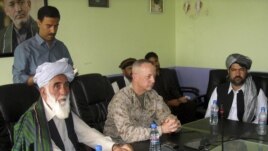 The commander of U.S. and NATO troops in Afghanistan, General John Allen, center, meets with the Governor of Logar Province, Allhaj Mohammad Tahir Sabari, left, south of Kabul, Afghanistan, June 8, 2012. 