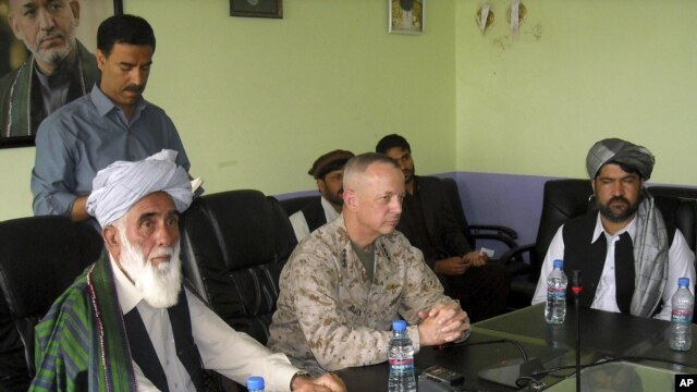 The commander of U.S. and NATO troops in Afghanistan, General John Allen, center, meets with the Governor of Logar Province, Allhaj Mohammad Tahir Sabari, left, south of Kabul, Afghanistan, June 8, 2012. 