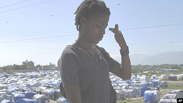A resident leaves a camp for victims affected by the January 12 earthquake in Port-au-Prince, 11 Jul 2010