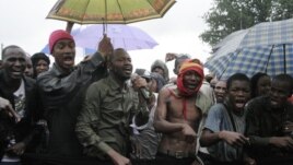People originally from Mali's north protest in the rain against the Islamist takeover of northern Mali, in the capital, Bamako, Mali, July 4, 2012.