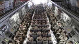 U.S. servicemen after boarding a transport plane before leaving for Afghanistan from the U.S. transit center at Manas airport, Bishkek, Kyrgyzstan, March 27, 2012.