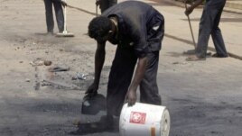 Workers outside the Qurtoba conference hall clean up debris after demonstrations by Sudanese university students and citizens yesterday in the capital Khartoum, Sudan, June 24, 2012.