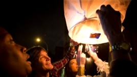 People release paper lanterns after lighting them outside Madiba, a restaurant named in honor of former South African President Nelson Mandela, in the Brooklyn borough of New York, Dec. 5, 2013.