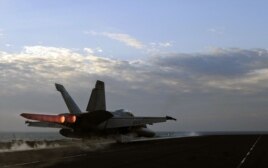 A U.S. Navy handout photo dated February 13, 2012 shows a F/A-18E Super Hornet fighter jet launching from the flight deck of the aircraft carrier USS Abraham Lincoln, part of the Bahrain-based U.S. 5th Fleet.