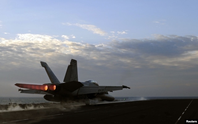 A U.S. Navy handout photo dated February 13, 2012 shows a F/A-18E Super Hornet fighter jet launching from the flight deck of the aircraft carrier USS Abraham Lincoln, part of the Bahrain-based U.S. 5th Fleet.