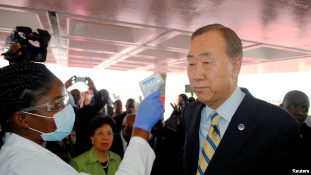 U.N. Secretary General Ban Ki-moon has his temperature checked upon arrival at the Roberts International airport in Liberia's capital Monrovia, Dec. 19, 2014.