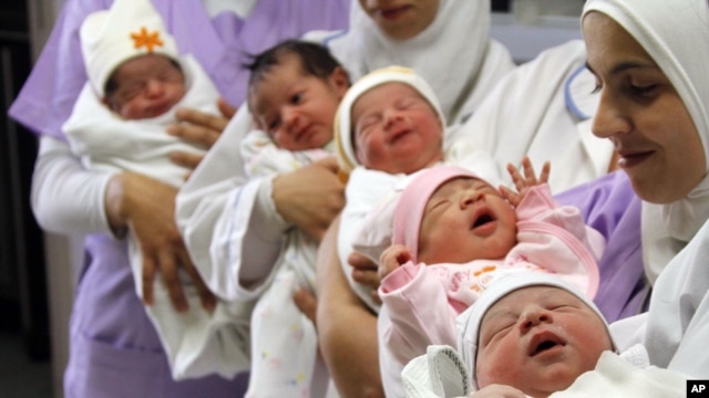 Nurses hold newborn babies in Sidon, Lebanon, Oct. 31, 2011. 