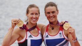 Britain's Helen Glover and Heather Stanning stand with their gold medals after the women's pair Final A at Eton Dorney during the London 2012 Olympic Games August 1, 2012.