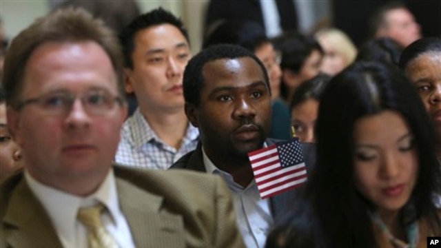 Zoltan Sznorfi, left, originally from Hungary, Benjamin Njoku, center, originally from Nigeria, and Keyan Chen, right, originally from China wait for the naturalization ceremony at historic Federal Hall to start, Friday, March 22, 2013 in New York.