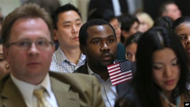 Zoltan Sznorfi, left, originally from Hungary, Benjamin Njoku, center, originally from Nigeria, and Keyan Chen, right, originally from China wait for the ... - 554FFB60-320E-4BA0-9C28-64C7E15C2315_w640_r1_s