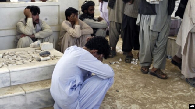 An Afghan mourns during the burial ceremony for Ahmad Wali Karzai, President Hamid Karzai's brother who was killed by a bodyguard on Tuesday, in Kandahar province July 13, 2011.
