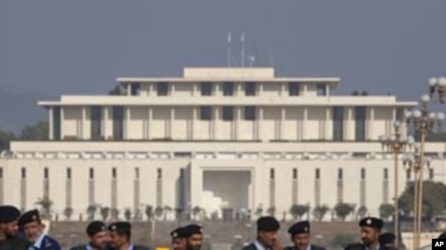 Policemen in riot gear stand guard, with parliament in the background, in Islamabad (File Photo)