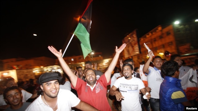 People dance in the streets as they celebrate the national election in Benghazi,Libya, July 7, 2012. 