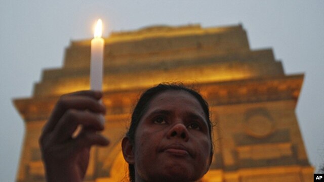 A mourner attends a candlelight prayer ceremony for nun Valsha John at the India Gate in New Delhi, November 22, 2011. John, 52, was beaten and hacked with an axe by unknown assailants in India's eastern Jharkhand state where she had led a campaign for fi