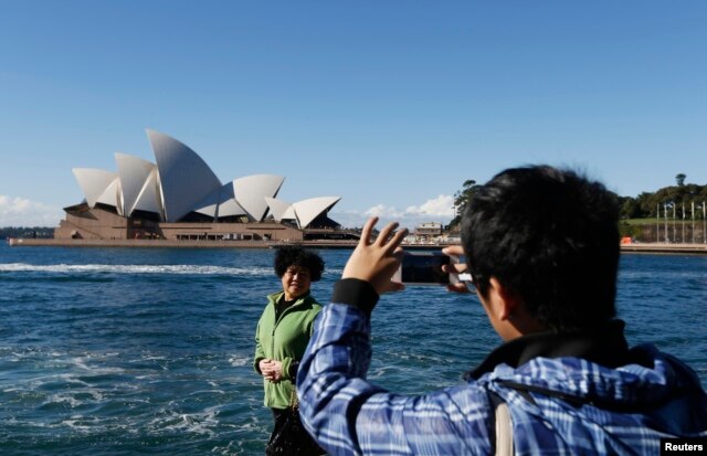 Một du khách Trung Quốc chụp ảnh trước Nhà hát Sydney.
