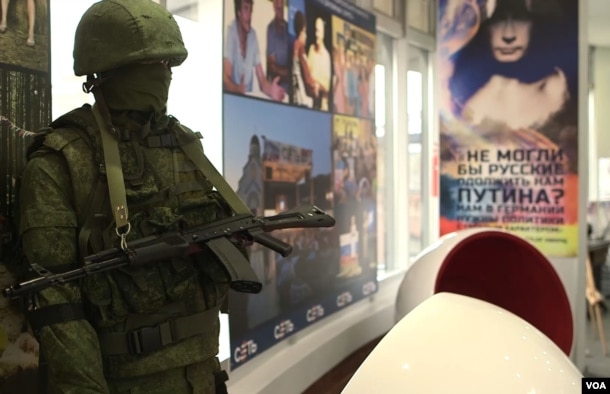 FILE - A mannequin soldier holding a rifle represents the "little green men" whom Russia dispatched to help annex Ukraine's Crimea. (VOA video screengrab)
