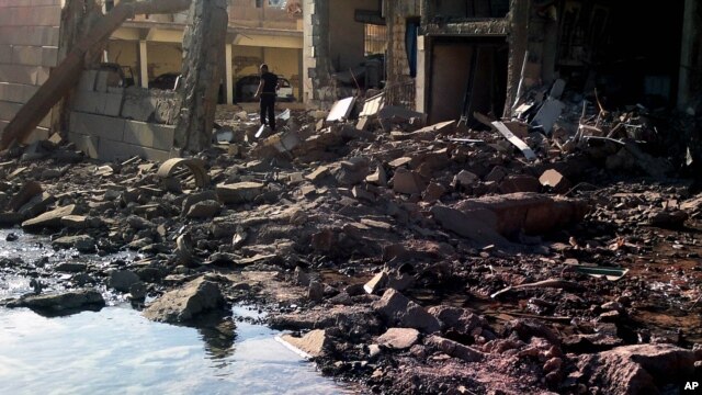 A suicide attacker detonates a car bomb at a Syrian security compound in a remote, predominantly Kurdish area, killing at least four people, Sept. 30, 2012.