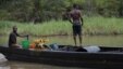Suspected oil thieves ride a wooden boat full of stolen crude oil on the creeks of Bayelsa, Nigeria, May 18, 2013.