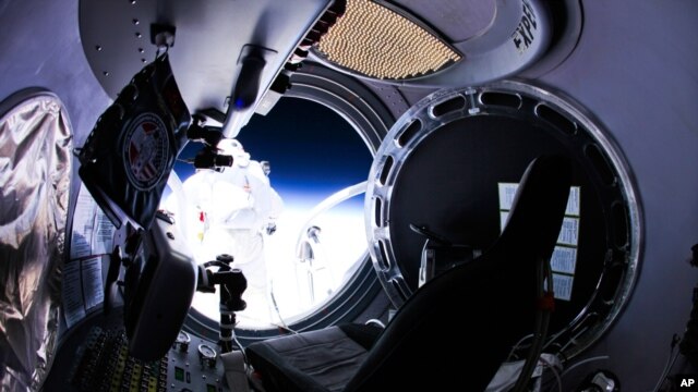 This photo provided by Red Bull Stratos shows pilot Felix Baumgartner of Austria as he jumps out of the capsule, October 14, 2012.  