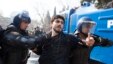 Riot police detain a protester during a rally in Baku, March 10, 2013.